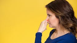 Side-view-profile-portrait-middle-aged-woman-covers-pinches-her-nose-with-hand-looks-with-disgust-something-stinks-bad-smell-situation-isolated-yellow-background.-Human-face-expression-body-language