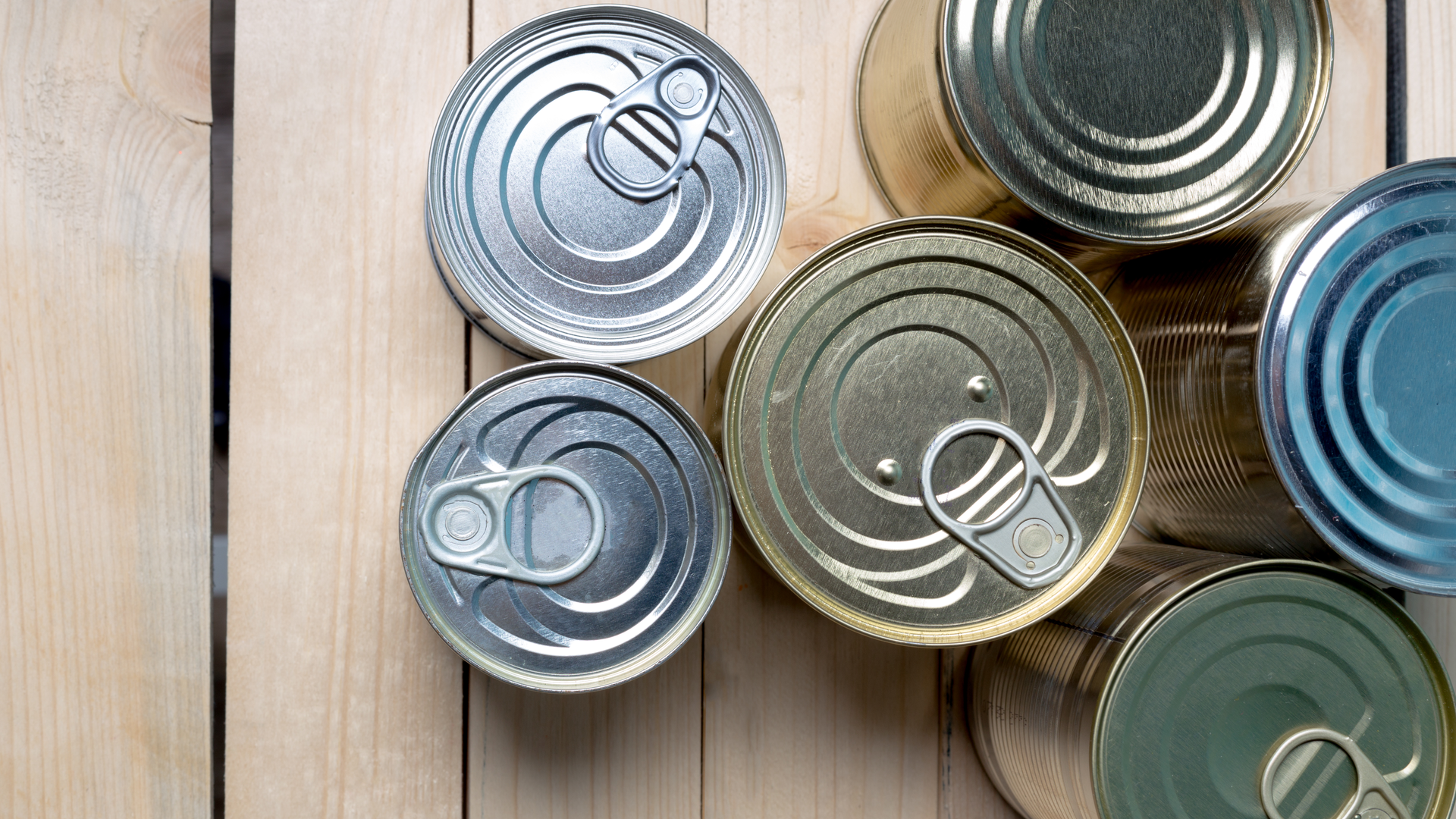 Tin cans for food on wooden background