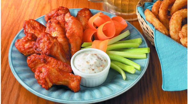 chicken wings with carrots and celery on a plate