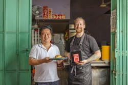 Loo Kia Chee (left) offered Good Meat’s chicken at his Loo's Hainanese Curry Rice, a well-known hawker stall in Singapore. On the right is Zach Tyndall, a Good Meat chef. Loo Kia Chee (left) offered Good Meat’s chicken at his Loo's Hainanese Curry Rice, a well-known hawker stall in Singapore. On the right is Zach Tyndall, a Good Meat chef.