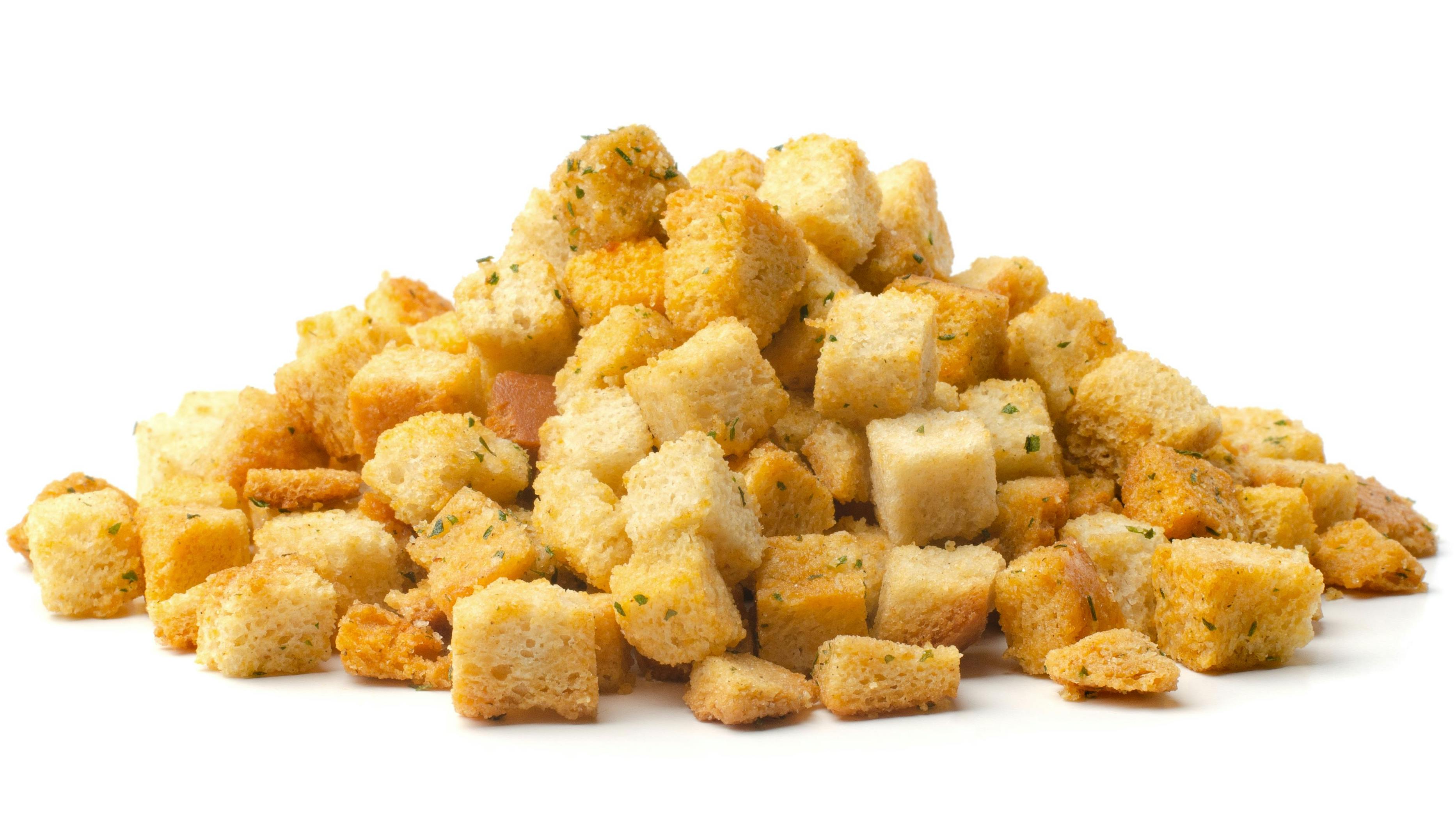 Pile of homemade bread croutons isolated on white background