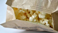 Microwave popcorn on a white background in a bag Microwave popcorn on a white background in a bag