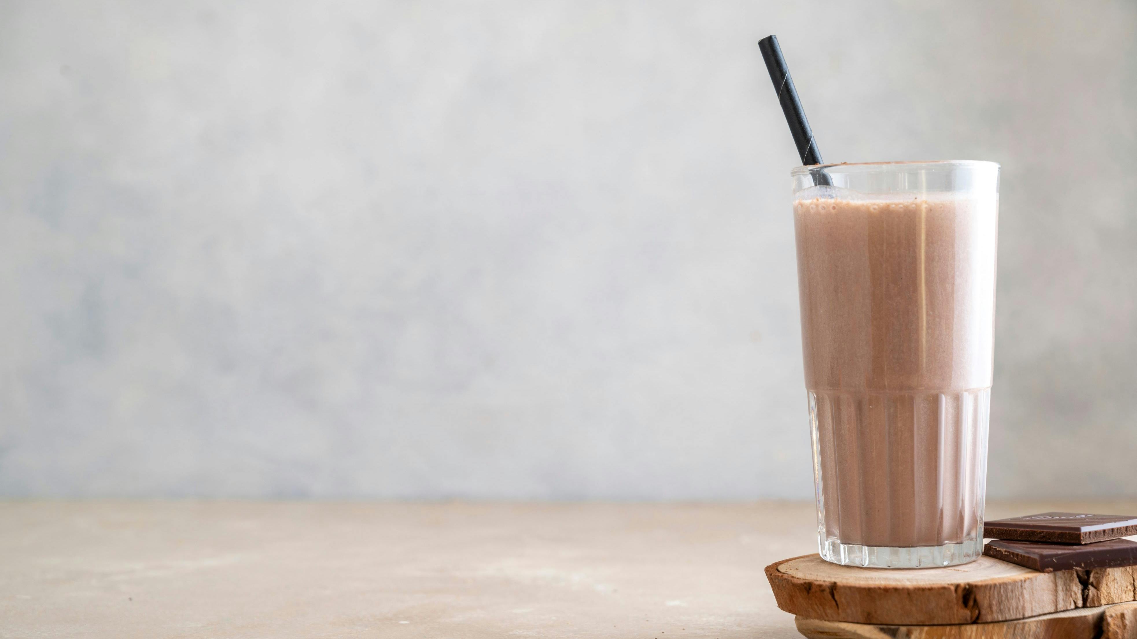 Chocolate protein drink in glass for nutrients and energy