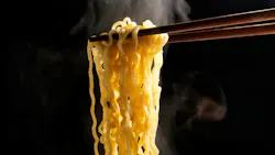 Lift With Wood Chopsticks And Fork To Pickup Noodle With Steam And Smoke Isolated On Black Background Lift With Wood Chopsticks And Fork To Pickup Noodle With Steam And Smoke Isolated On Black Background