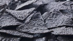 Image of a bunch of crunchy blue tortilla chips Image of a bunch of crunchy blue tortilla chips