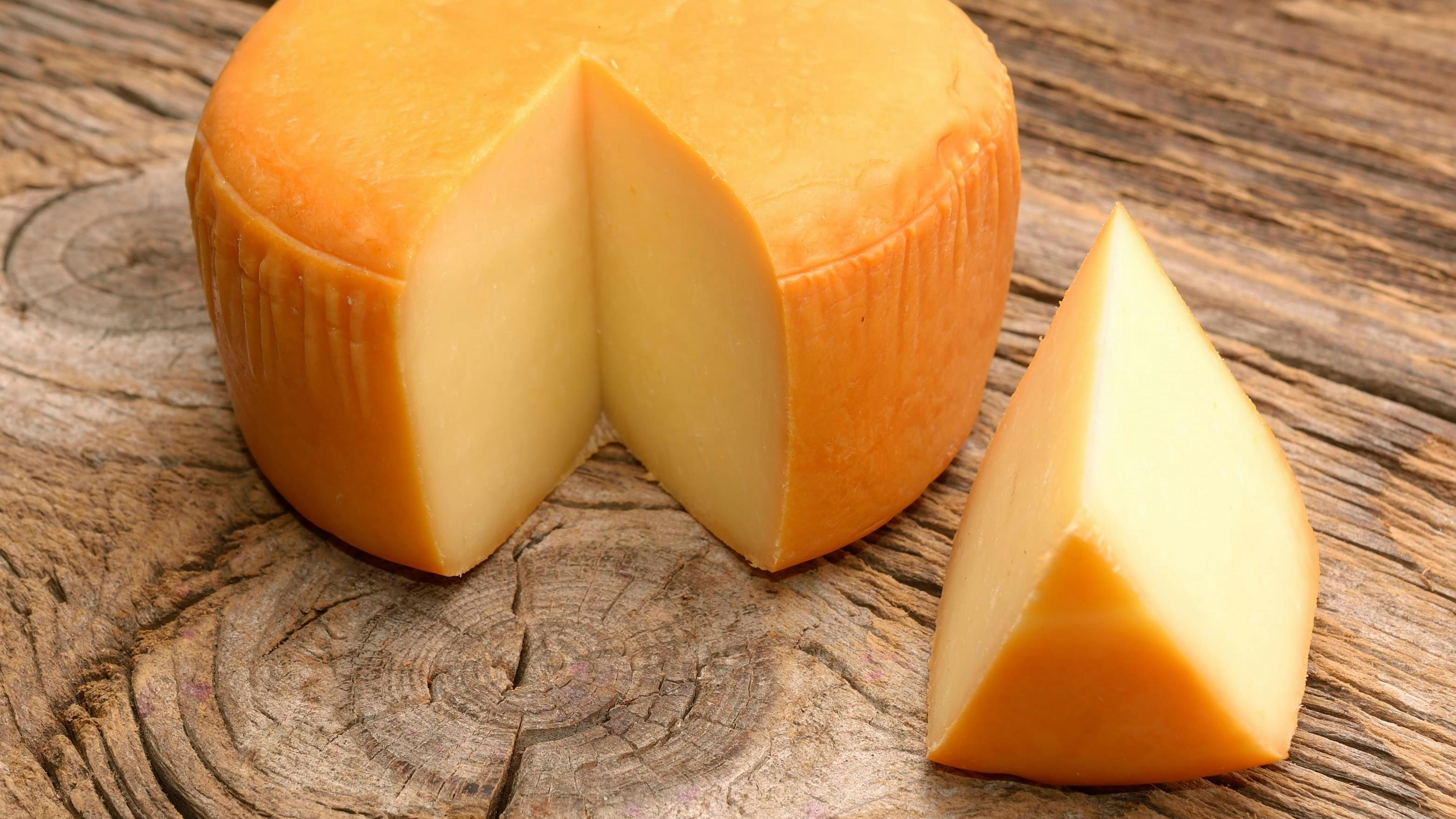 Cheese wheel on wooden table