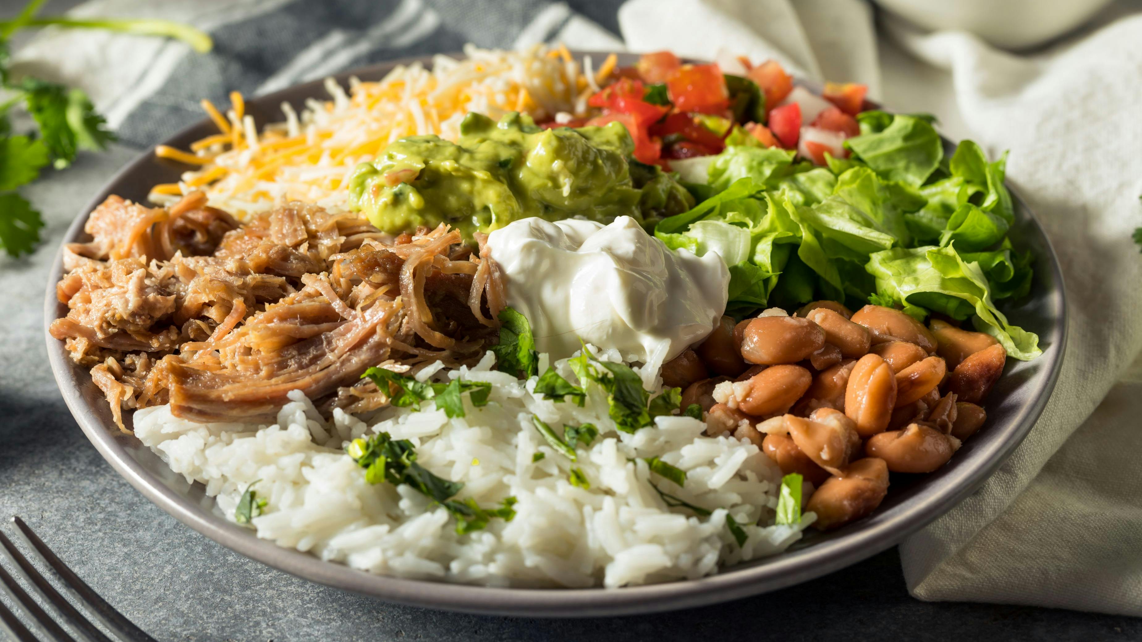 Healthy Homemade Mexican Carnitas Burrito Bowl Cilantro and Guacamole