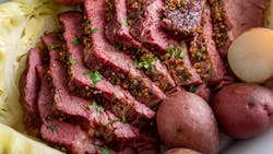 Corned beef with cabbage and potatoes on a serving platter, irish recipe idea for St Patricks day Corned beef with cabbage and potatoes on a serving platter, irish recipe idea for St Patricks day