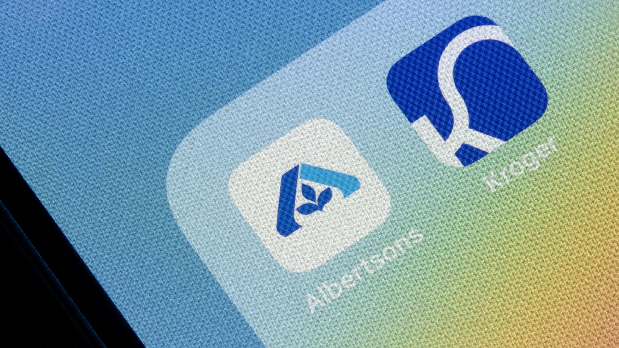 Albertsons and Kroger mobile app icons are seen on an iPhone. The Kroger-Albertsons merger has raised fears of store closures.