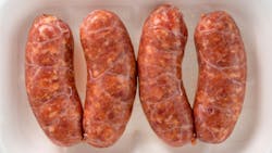 Italian salamella sausage in plastic food tray for sale in the market isolated on white in top view Italian salamella sausage in plastic food tray for sale in the market isolated on white in top view