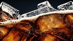 Cola with Ice. Close up of the ice cubes in cola water. Texture of carbonate drink with bubbles in glass. Cola with Ice. Close up of the ice cubes in cola water. Texture of carbonate drink with bubbles in glass.