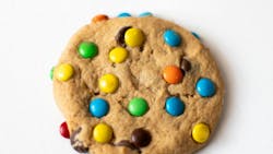 One Single freshly baked Crisp Chocolate Chip Cookie with colorful candy on a white background One Single freshly baked Crisp Chocolate Chip Cookie with colorful candy on a white background