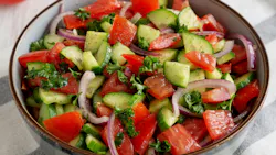 Homemade Mediterranean Cucumber Tomato Salad in a Bowl, side view. Homemade Mediterranean Cucumber Tomato Salad in a Bowl, side view.