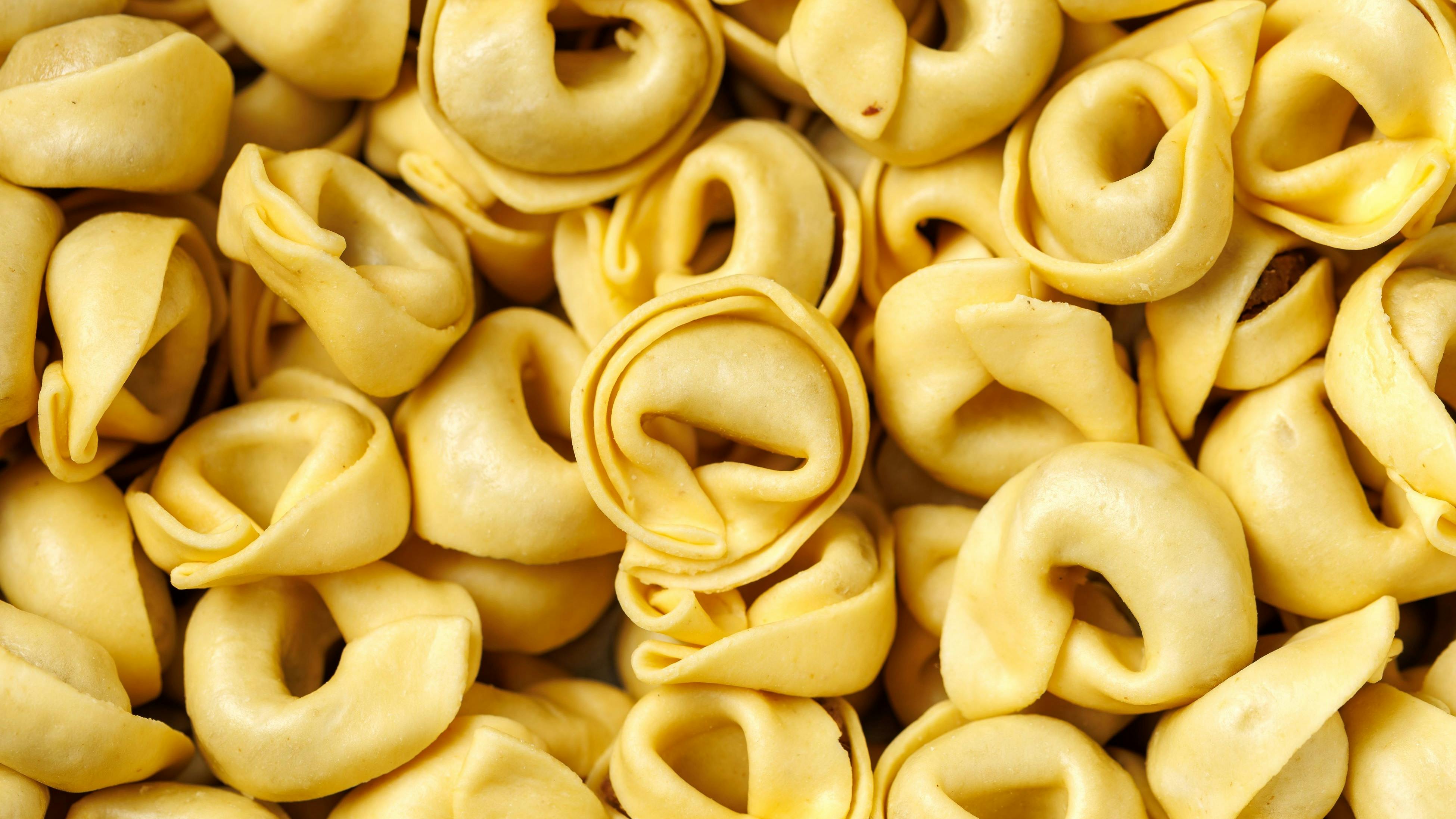 Raw homemade pasta tortellini, ravioli with mushrooms