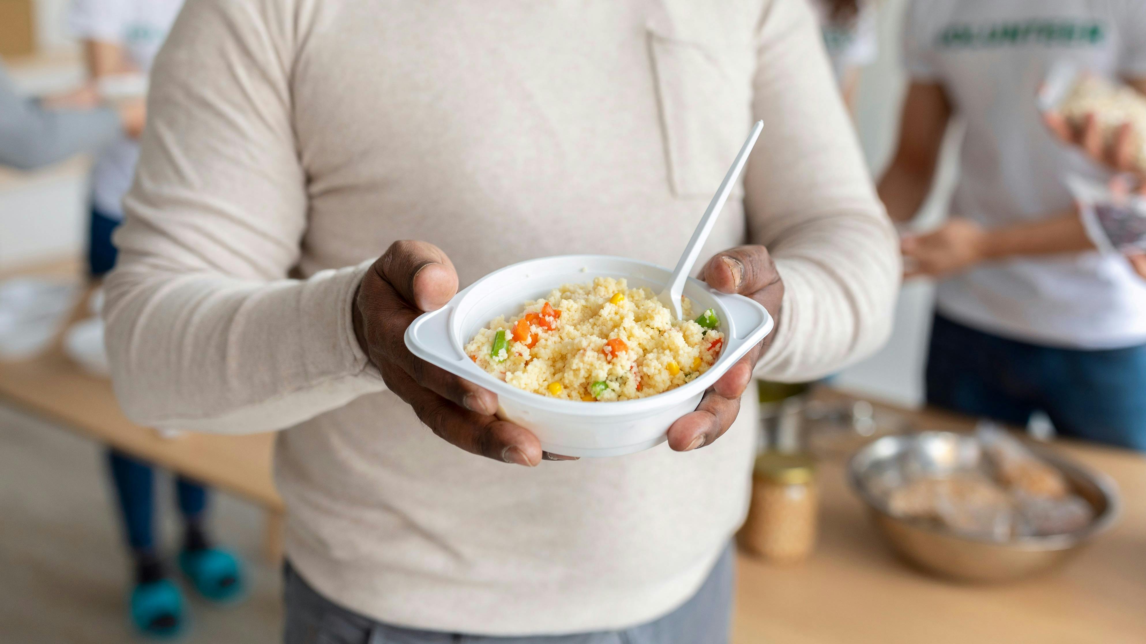 African american senior man holding plate with meal