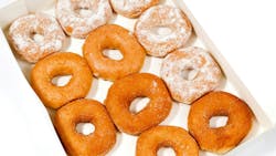 two separate boxes filled with a variety of donuts. two separate boxes filled with a variety of donuts.