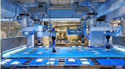 High-tech robots put French croissants into containers. High-tech robots put French croissants into containers.