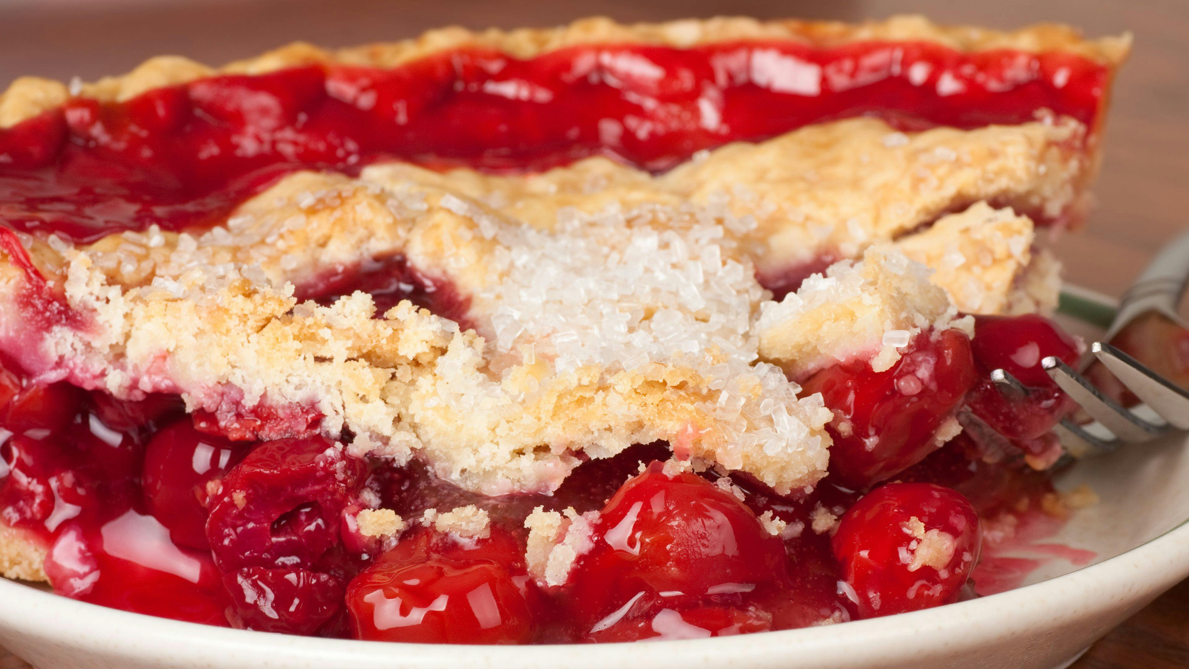 Closeup of a slice of cherry pie on a plate