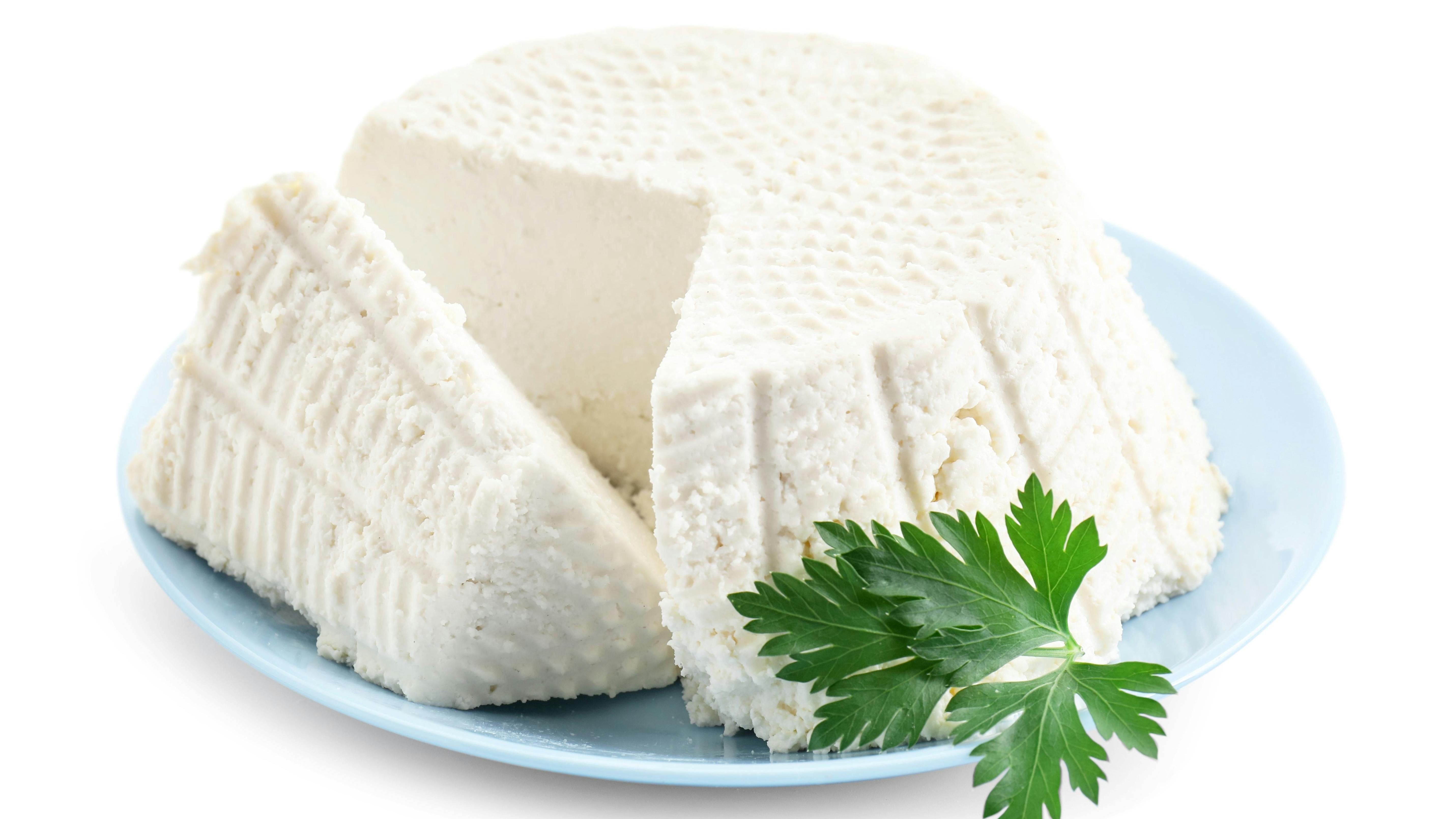 Tasty ricotta (cream cheese) and parsley isolated on white