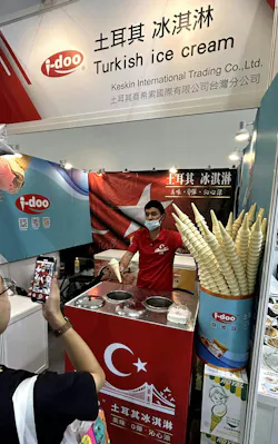 Keskin International Trading Co. had an ice cream man serving Turkish ice cream in cones to attendees on the end of a long paddle, demonstrating the unique stickiness of the frosty treat. Keskin International Trading Co. had an ice cream man serving Turkish ice cream in cones to attendees on the end of a long paddle, demonstrating the unique stickiness of the frosty treat.