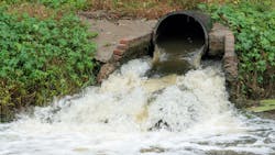 Waste water sewage from a pipe into the river. Water pollution, environment contamination concept Waste water sewage from a pipe into the river. Water pollution, environment contamination concept