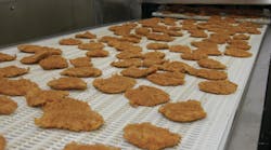 Breaded chicken products travel along a conveyor to be packed for a customer at Wayne-Sanderson Farms’ Decatur, Ala., prepared foods plant. Breaded chicken products travel along a conveyor to be packed for a customer at Wayne-Sanderson Farms’ Decatur, Ala., prepared foods plant.