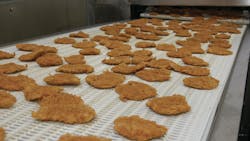Breaded chicken products travel along a conveyor to be packed for a customer at Wayne-Sanderson Farms’ Decatur, Ala., prepared foods plant. Breaded chicken products travel along a conveyor to be packed for a customer at Wayne-Sanderson Farms’ Decatur, Ala., prepared foods plant.
