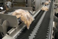 Batter-breaded wings are bagged and sent on to the packaging area to be placed in cartons by pick-and-place robots. Batter-breaded wings are bagged and sent on to the packaging area to be placed in cartons by pick-and-place robots.