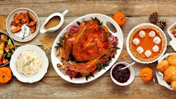 Thanksgiving turkey dinner. Above view table scene on a rustic wood banner background. Turkey, mashed potatoes, stuffing, pumpkin pie and sides. Thanksgiving turkey dinner. Above view table scene on a rustic wood banner background. Turkey, mashed potatoes, stuffing, pumpkin pie and sides.