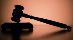 Conceptual Silhouette Small Wooden Gavel Resting on the Table with Brown Background Conceptual Silhouette Small Wooden Gavel Resting on the Table with Brown Background