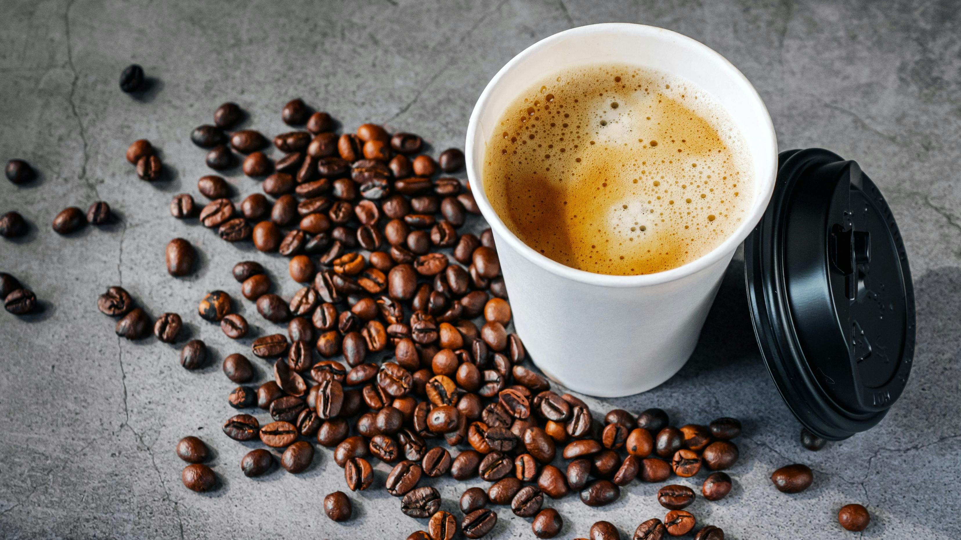 Coffee espresso wite smoke in paper Coffee cup and bean